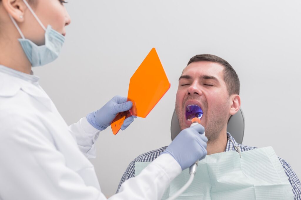 Dentist in Norwich examining a patient's gums during a dental checkup for signs of gum disease