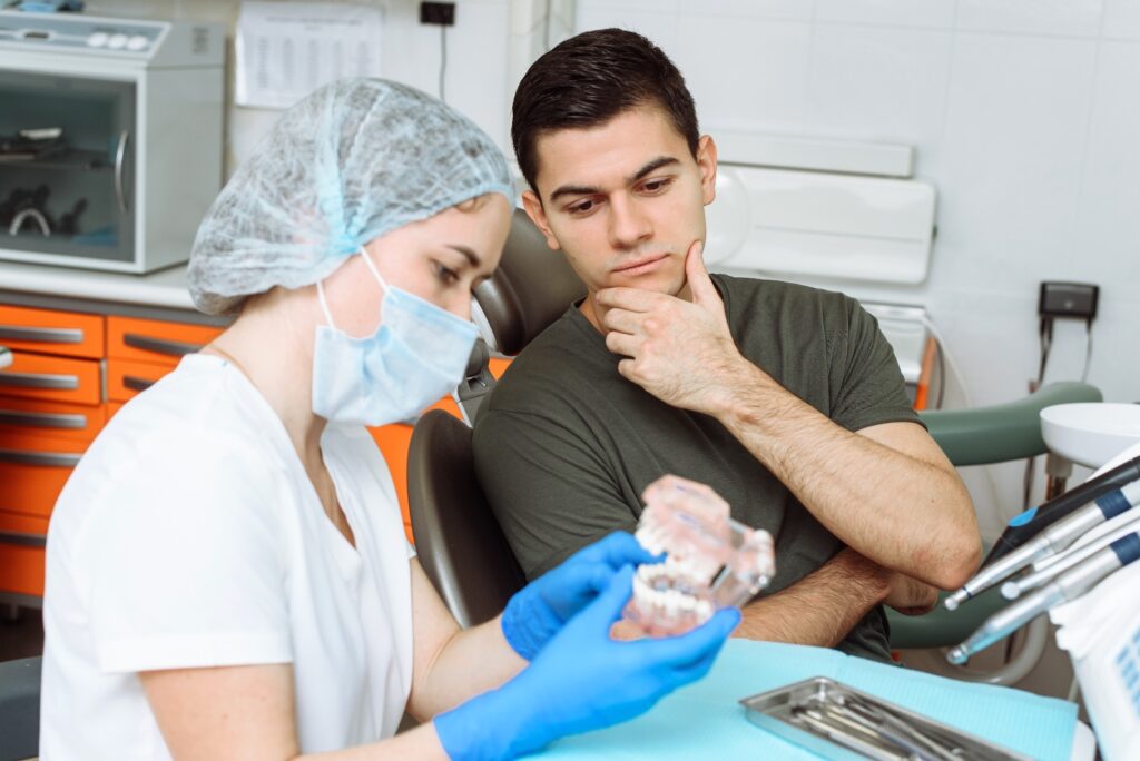 Patient discussing root canal treatment and tooth extraction options with a dentist in Norwich at Pearl Dental Surgery